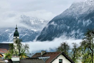 Panoramic view of buildings and trees against sky