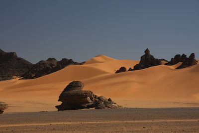 Rock formations in desert against sky acacus mountain, libya