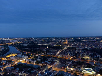 High angle view of illuminated cityscape against sky at dusk