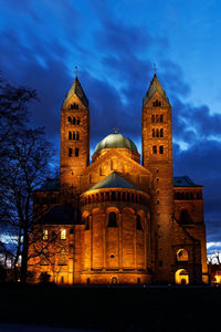 Illuminated building against sky at dusk