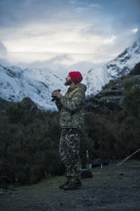 Man holding binoculars looking at view