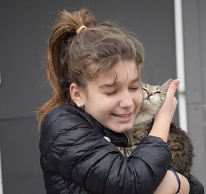 Portrait of happy girl holding camera