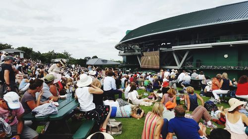 Crowd of people at music concert against sky