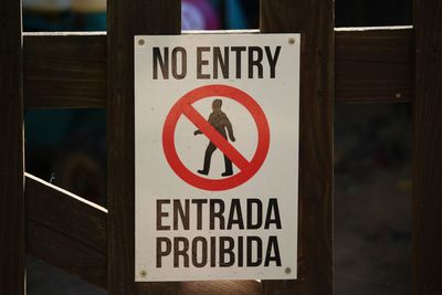 Close-up of warning sign on fence