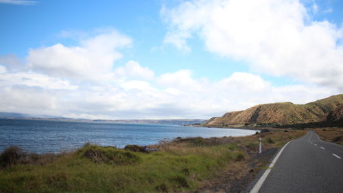 Panoramic view of road by sea against sky