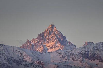 Scenic view of snowcapped mountains against clear sky