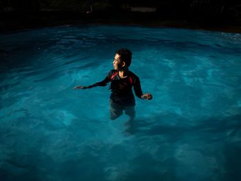 High angle view of boy swimming in sea