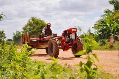 Tractor on road against sky