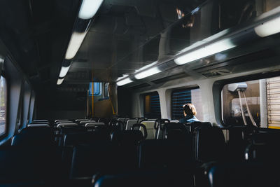 Rear view of woman sitting in bus