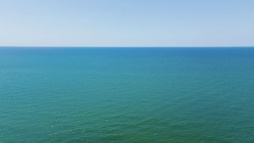 Scenic view of blue sea against clear sky