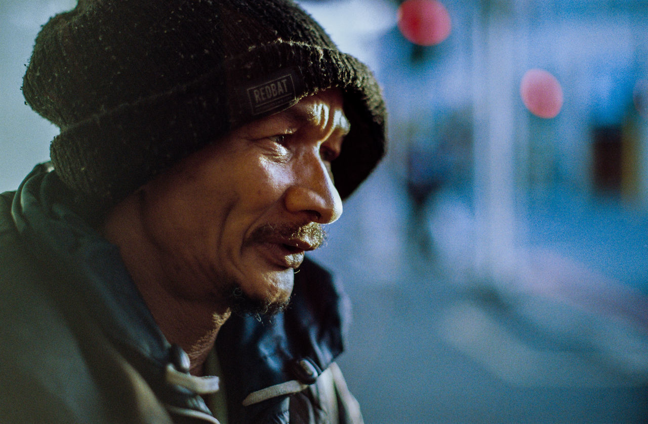 headshot, lifestyles, real people, one person, focus on foreground, portrait, leisure activity, looking, close-up, looking away, young adult, clothing, mid adult, contemplation, side view, day, smiling, young men, hairstyle, human face, warm clothing