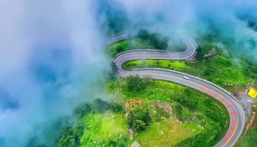 High angle view of cars on road against trees