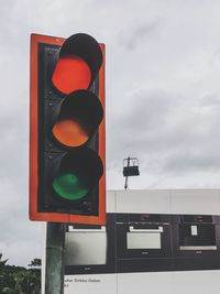 Low angle view of road sign against sky
