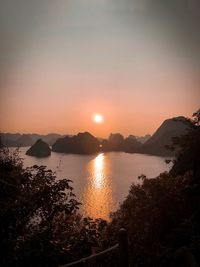 Scenic view of lake against sky during sunset