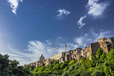 Low angle view of buildings against cloudy sky