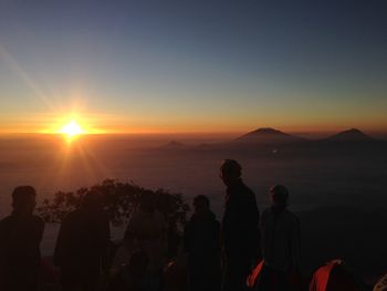 Silhouette of people at sunset