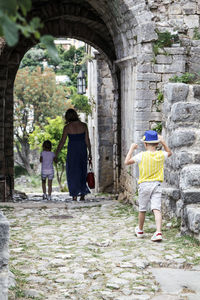 Rear view of man and woman walking on street