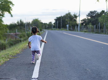 Boy walking on road