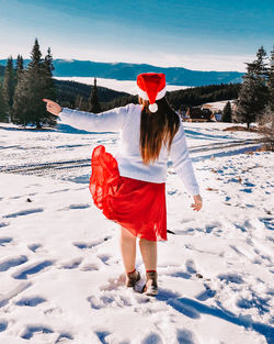 Woman with umbrella on snow during winter