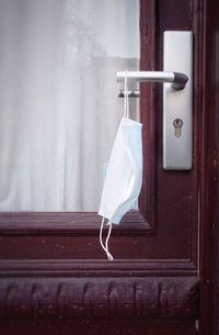 Close-up of clothes hanging on window of building