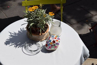 Potted plant and decorated stone on restaurant table