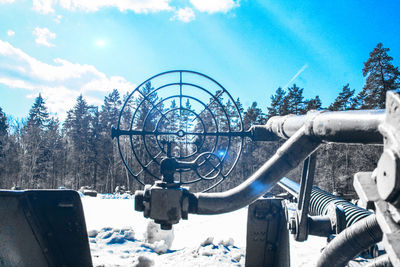 Low angle view of chain swing ride against sky
