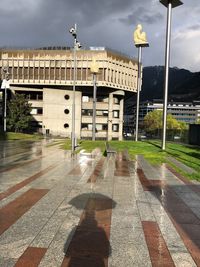 View of street against cloudy sky