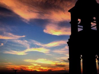 Silhouette of built structure against sunset sky