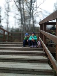 Boy sitting on staircase