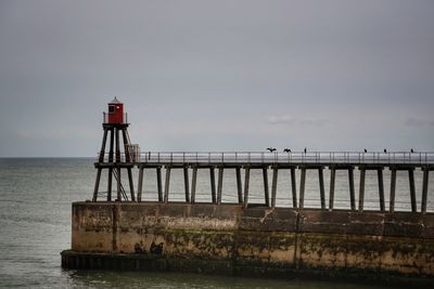 Pier over sea against sky