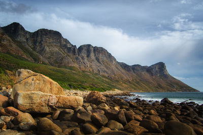 Scenic view of sea and mountains against sky