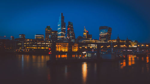 Building light reflections on waterfront during the night.