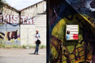 Close-up of text on tree against building