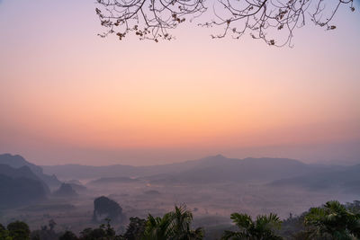 Scenic view of silhouette mountains against sky during sunset