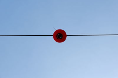 Low angle view of light bulb against clear sky