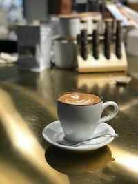 Close-up of cappuccino on table at cafe