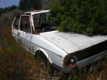 Abandoned car on field