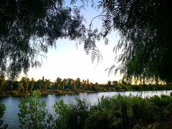 Scenic view of lake against sky at sunset