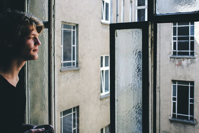 Side view of men  looking through window