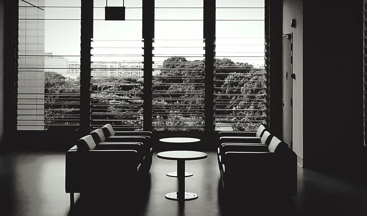 indoors, window, architecture, built structure, building exterior, chair, empty, absence, glass - material, modern, sunlight, in a row, day, shadow, table, building, no people, city, residential building, home interior