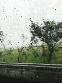 Road seen through wet window during rainy season