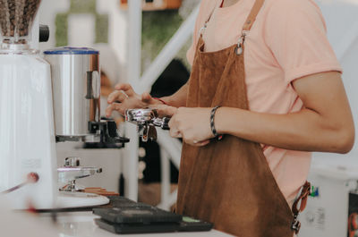 Midsection of man working in coffee