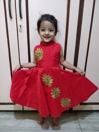 Portrait of smiling girl standing on tiled floor