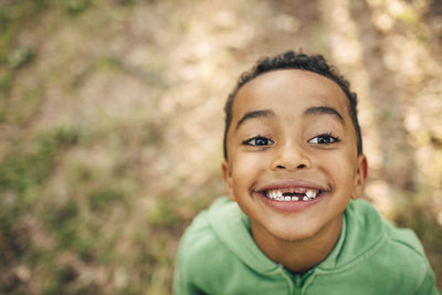 High angle view of smiling boy with gap toothed in park