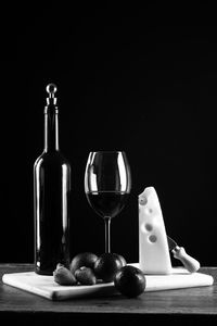 Wine glasses on table against black background