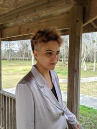 Smiling young woman standing in gazebo