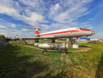 View of airplane on airport runway against sky