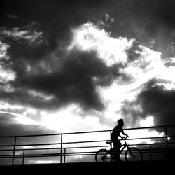 Silhouette of man against cloudy sky