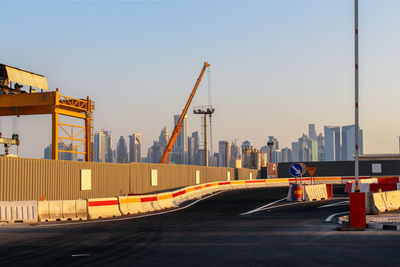 View of construction site by buildings against sky