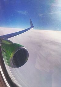 Close-up of airplane wing against sky